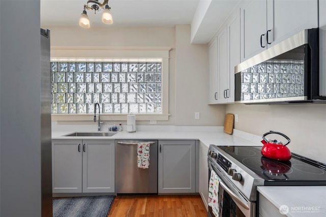 503 12th Ave E, Seattle, WA 98102 - kitchen featuring appliances with stainless steel finishes, light countertops, light wood-type flooring, and gray cabinets