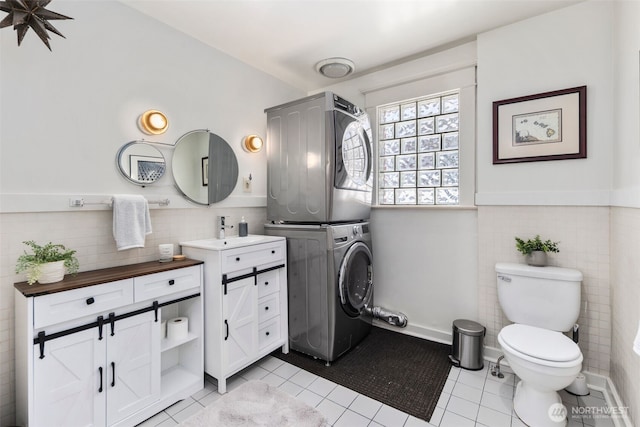 503 12th Ave E, Seattle, WA 98102 - bathroom with estacked washer and dryer, tile patterned flooring, tile walls, vanity, and a wainscoted wall