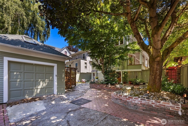 503 12th Ave E, Seattle, WA 98102 - view of side of home with a garage, a shingled roof, and driveway