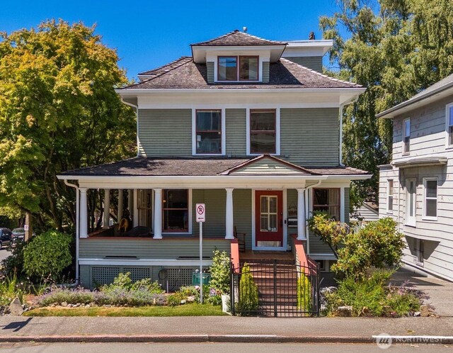 503 12th Ave E, Seattle, WA 98102 - american foursquare style home with covered porch and a fenced front yard
