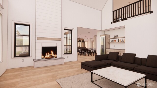 6320 240th Way NE, Redmond, WA 98053 - living room featuring wood finished floors, a warm lit fireplace, and a high ceiling