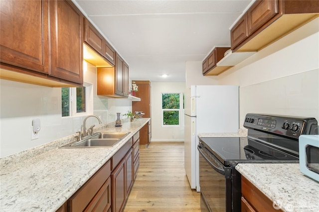 4715 N Island Dr E, Bonney Lake, WA 98391 - kitchen with electric range, light wood-style flooring, brown cabinetry, light stone countertops, and recessed lighting