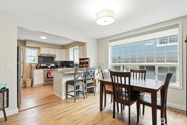 3827 Wetmore Ave, Everett, WA 98201 - dining area with light wood-type flooring and baseboards