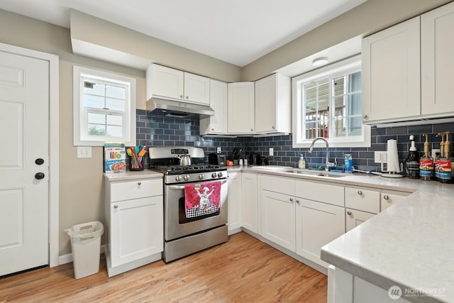 3827 Wetmore Ave, Everett, WA 98201 - kitchen with gas stove, under cabinet range hood, plenty of natural light, and tasteful backsplash
