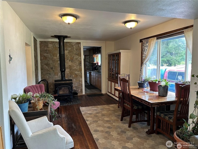 715 Copalis Beach Rd, Copalis Beach, WA 98535 - dining space featuring a wood stove and dark wood finished floors