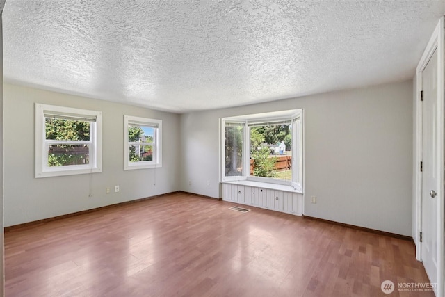 1425 N 1st Ave, Kelso, WA 98626 - unfurnished room featuring wood finished floors and a textured ceiling