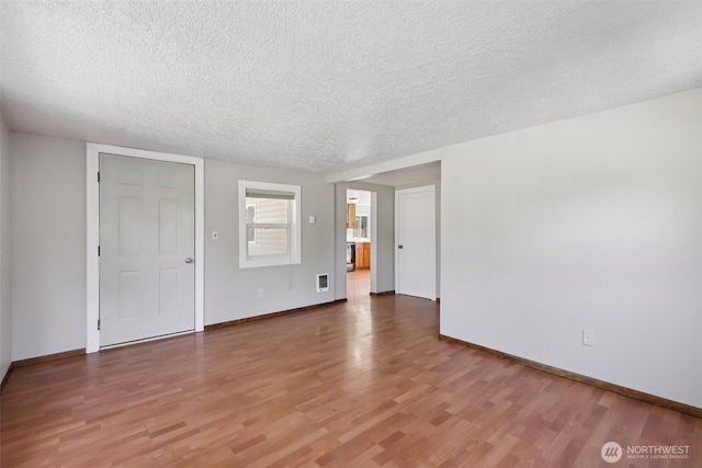 1425 N 1st Ave, Kelso, WA 98626 - unfurnished room with a textured ceiling and wood finished floors