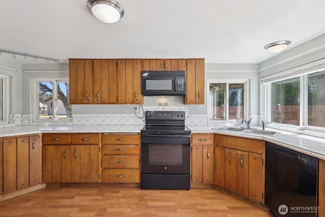 1425 N 1st Ave, Kelso, WA 98626 - kitchen with black appliances, brown cabinets, and light wood-style flooring