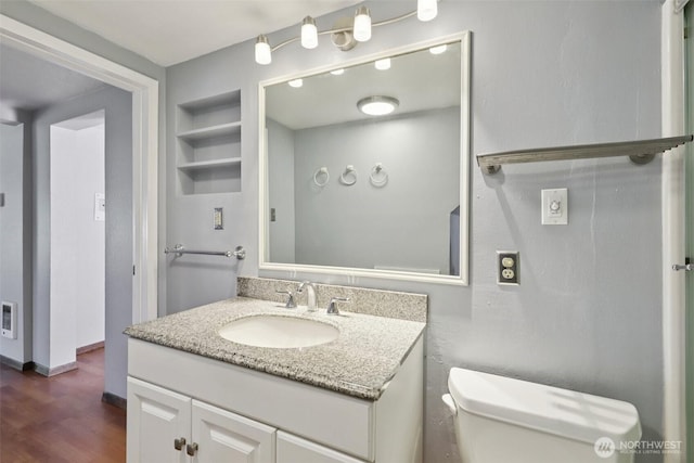1425 N 1st Ave, Kelso, WA 98626 - half bathroom featuring vanity, wood finished floors, and built in shelves