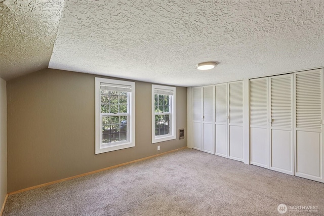 1425 N 1st Ave, Kelso, WA 98626 - unfurnished bedroom featuring two closets, carpet, and lofted ceiling