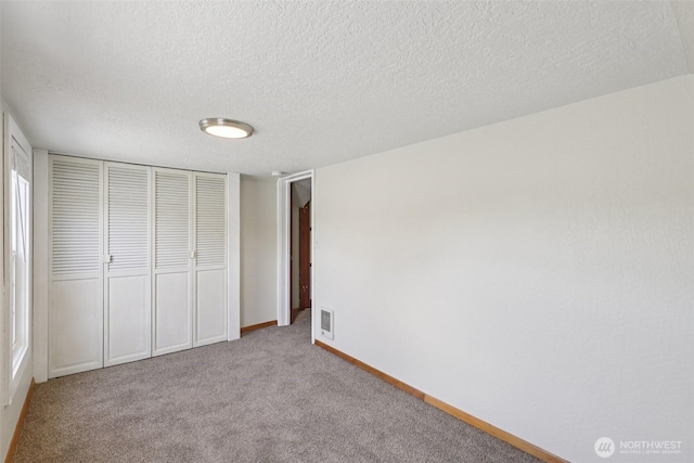 1425 N 1st Ave, Kelso, WA 98626 - unfurnished bedroom with a closet, carpet floors, and a textured ceiling