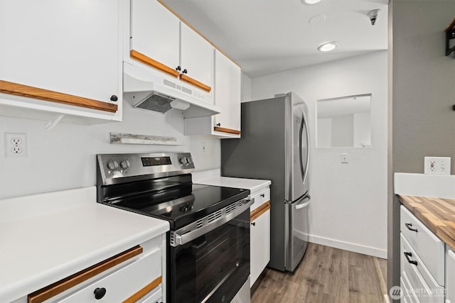 7453 Newcastle Golf Club Rd Unit L103, Newcastle, WA 98059 - kitchen featuring appliances with stainless steel finishes, under cabinet range hood, light wood finished floors, and white cabinetry