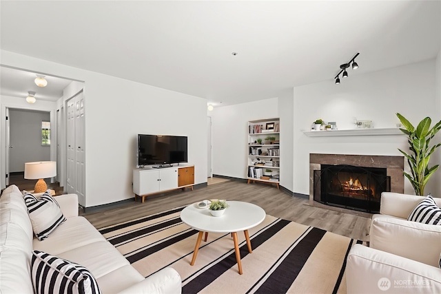 7453 Newcastle Golf Club Rd Unit L103, Newcastle, WA 98059 - living room featuring wood finished floors and a high end fireplace