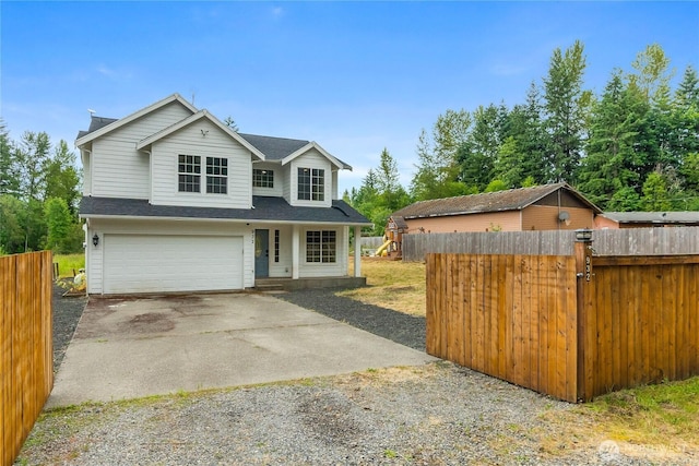 932 Tipsoo Loop N, Rainier, WA 98576 - traditional home featuring gravel driveway, a garage, and roof with shingles