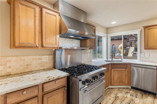 932 Tipsoo Loop N, Rainier, WA 98576 - kitchen featuring appliances with stainless steel finishes, wall chimney range hood, light stone counters, decorative backsplash, and brown cabinets