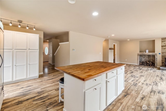 932 Tipsoo Loop N, Rainier, WA 98576 - kitchen featuring wood counters, light wood-type flooring, white cabinetry, a center island, and recessed lighting
