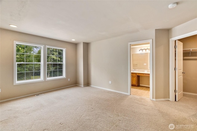 932 Tipsoo Loop N, Rainier, WA 98576 - unfurnished bedroom with a walk in closet, light colored carpet, connected bathroom, recessed lighting, and a closet