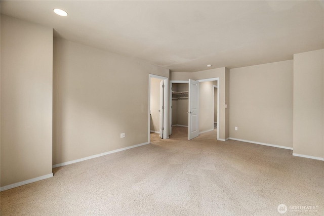 932 Tipsoo Loop N, Rainier, WA 98576 - unfurnished bedroom featuring light colored carpet, recessed lighting, and a walk in closet