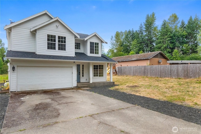 932 Tipsoo Loop N, Rainier, WA 98576 - traditional-style home featuring a garage, driveway, a shingled roof, and a porch