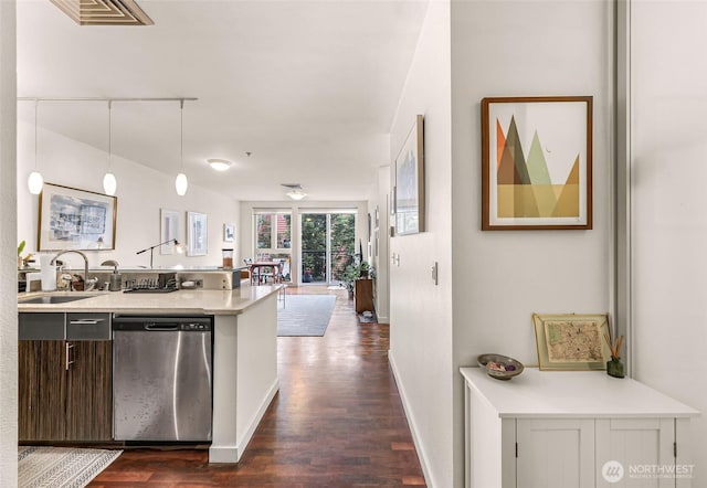 3104 Western Ave Unit 610, Seattle, WA 98121 - kitchen featuring stainless steel dishwasher, light countertops, dark wood-style floors, and pendant lighting
