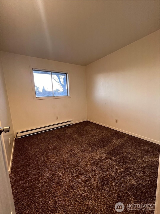 401 Biggs Dr, Moses Lake, WA 98837 - empty room featuring a baseboard heating unit and dark colored carpet