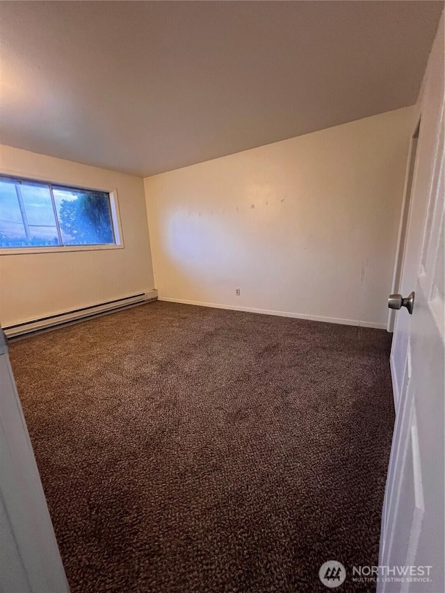 401 Biggs Dr, Moses Lake, WA 98837 - spare room featuring baseboard heating and dark colored carpet