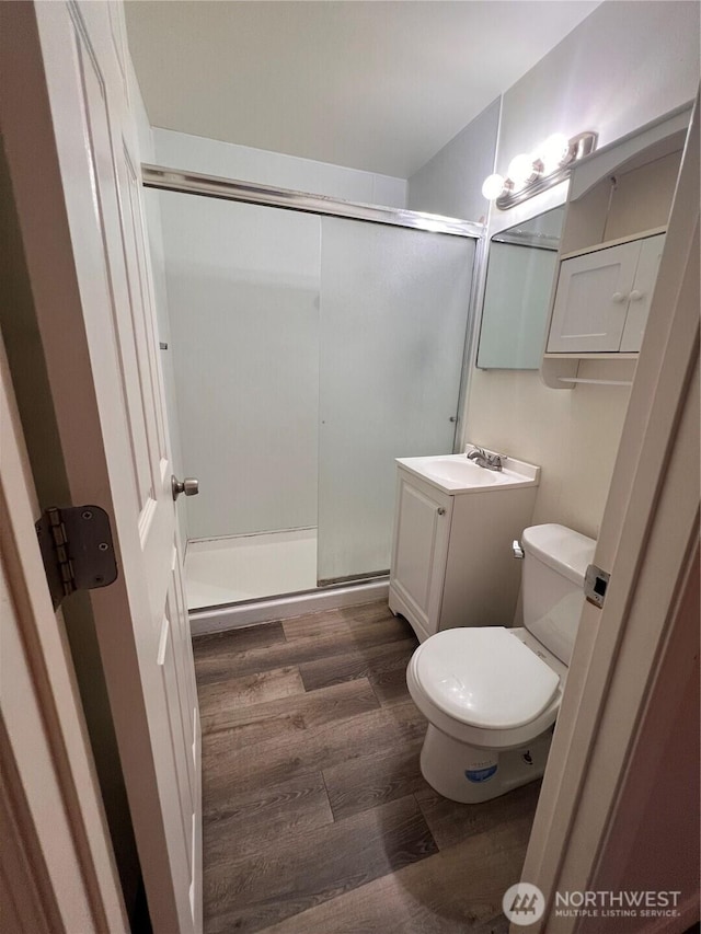 401 Biggs Dr, Moses Lake, WA 98837 - full bath featuring wood finished floors, vanity, and a shower stall