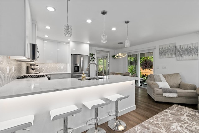 8254 Breeze Loop, Blaine, WA 98230 - kitchen with stainless steel appliances, a peninsula, white cabinetry, modern cabinets, and light stone counters