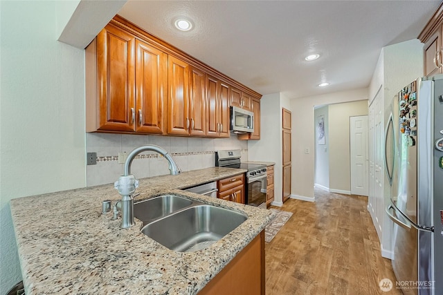 4164 Factoria Blvd SE Unit B11, Bellevue, WA 98006 - kitchen featuring stainless steel appliances, brown cabinetry, tasteful backsplash, and recessed lighting