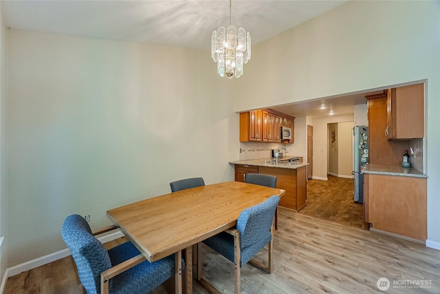 4164 Factoria Blvd SE Unit B11, Bellevue, WA 98006 - dining space with a chandelier, light wood-style flooring, and a high ceiling