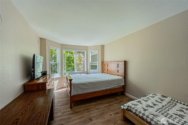 4164 Factoria Blvd SE Unit B11, Bellevue, WA 98006 - bedroom featuring wood finished floors and a textured wall