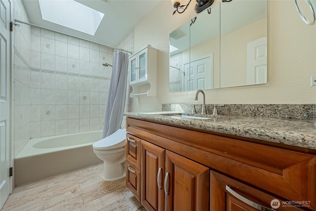 4164 Factoria Blvd SE Unit B11, Bellevue, WA 98006 - bathroom featuring a skylight, wood finished floors, shower / bath combination with curtain, and vanity