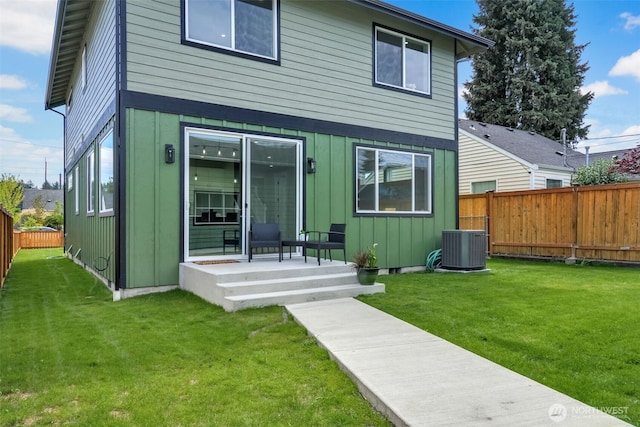 6410 S Fife St, Tacoma, WA 98409 - rear view of property featuring board and batten siding and a fenced backyard