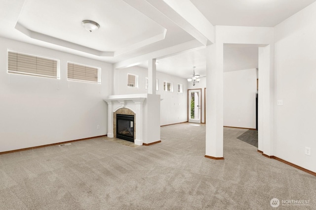 18214 97th Avenue Ct E, Puyallup, WA 98375 - unfurnished living room featuring carpet floors, a tile fireplace, a chandelier, and a tray ceiling