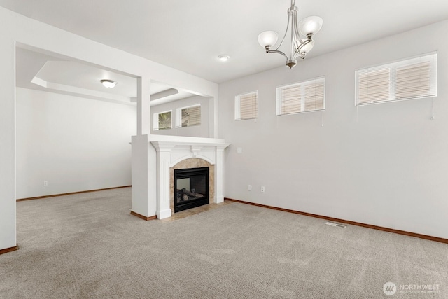 18214 97th Avenue Ct E, Puyallup, WA 98375 - unfurnished living room with carpet floors, a fireplace, and a chandelier