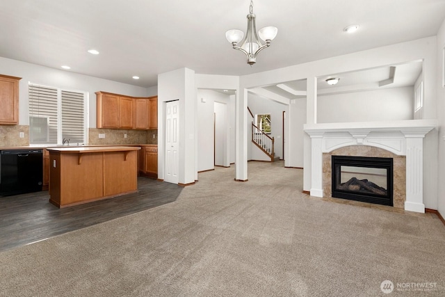 18214 97th Avenue Ct E, Puyallup, WA 98375 - kitchen with dishwasher, open floor plan, dark carpet, light countertops, and a breakfast bar area