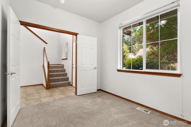 18214 97th Avenue Ct E, Puyallup, WA 98375 - spare room featuring healthy amount of natural light, light colored carpet, and stairway