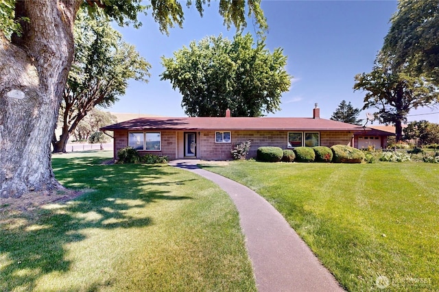 238 Patit Rd, Dayton, WA 99328 - ranch-style house with a chimney, a front yard, and an attached garage