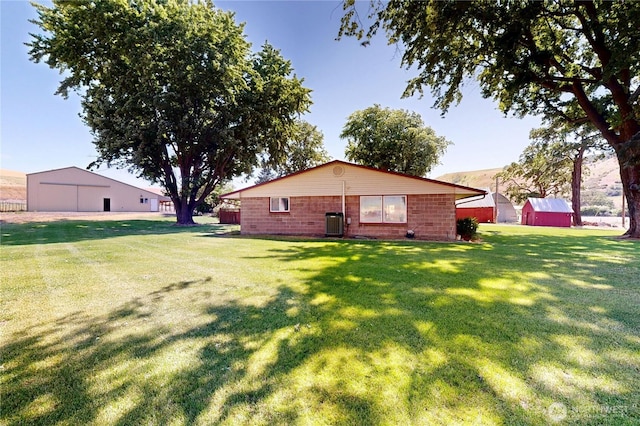 238 Patit Rd, Dayton, WA 99328 - back of house featuring an outbuilding and a lawn