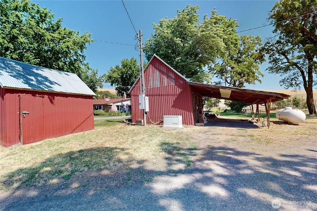 238 Patit Rd, Dayton, WA 99328 - view of pole building featuring a lawn and an attached carport