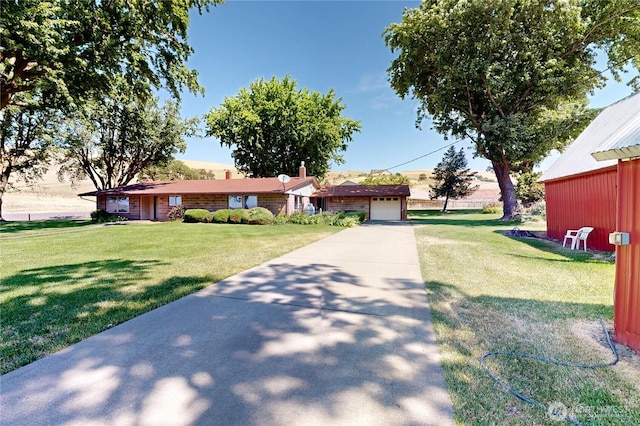 238 Patit Rd, Dayton, WA 99328 - ranch-style house with concrete driveway, a front lawn, and an attached garage