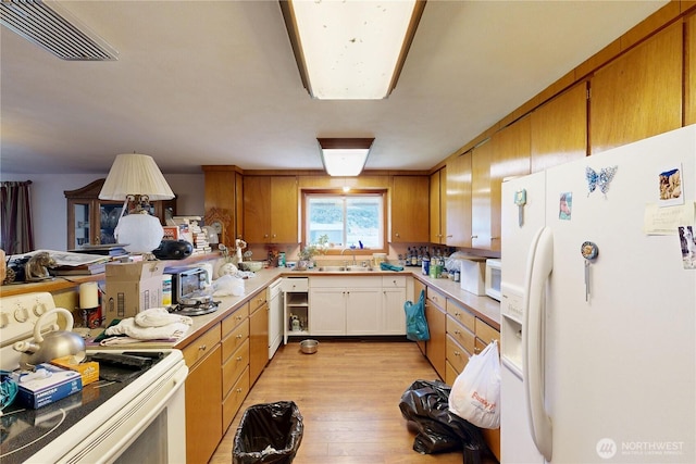 238 Patit Rd, Dayton, WA 99328 - kitchen featuring white appliances, light wood-type flooring, light countertops, and brown cabinets