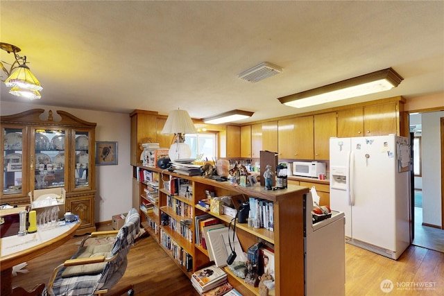 238 Patit Rd, Dayton, WA 99328 - kitchen featuring white appliances, light wood-style flooring, and pendant lighting
