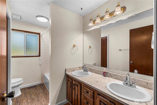 1201 Poe St, Wenatchee, WA 98801 - bathroom featuring double vanity, wood finished floors, and tub / shower combination