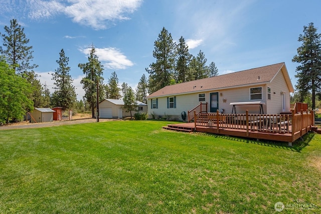 2207 W Depot Springs Rd, Spangle, WA 99031 - rear view of house featuring a detached garage, a yard, a deck, and a storage shed
