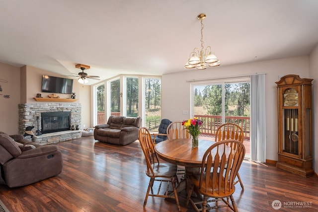 2207 W Depot Springs Rd, Spangle, WA 99031 - dining room featuring a fireplace, wood finished floors, a chandelier, and a ceiling fan
