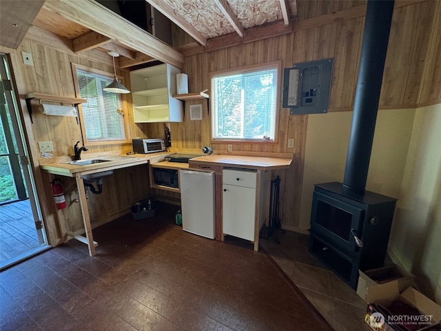 7379 Hideaway Ln, Anacortes, WA 98221 - kitchen featuring electric panel, wooden walls, light countertops, a wood stove, and open shelves