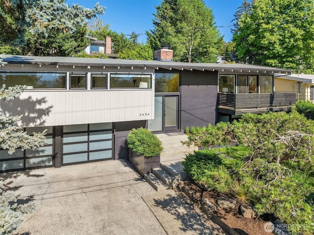 2434 64th Ave SE, Mercer Island, WA 98040 - view of front of property with a chimney, brick siding, driveway, and a garage
