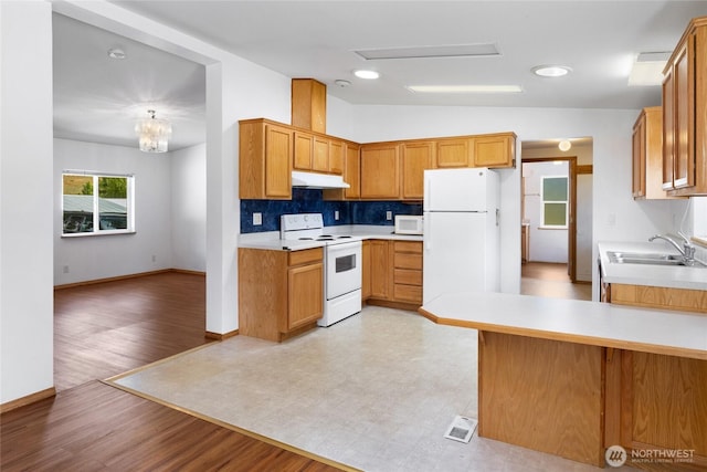 101 Twin Lakes Rd, Cle Elum, WA 98922 - kitchen featuring white appliances, under cabinet range hood, light countertops, vaulted ceiling, and tasteful backsplash