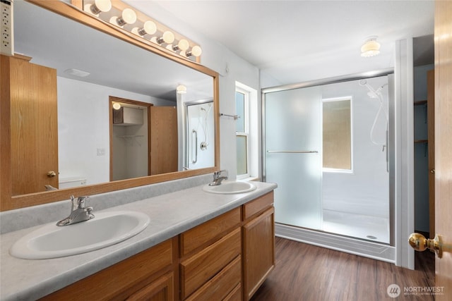 101 Twin Lakes Rd, Cle Elum, WA 98922 - bathroom with a stall shower, double vanity, and wood finished floors